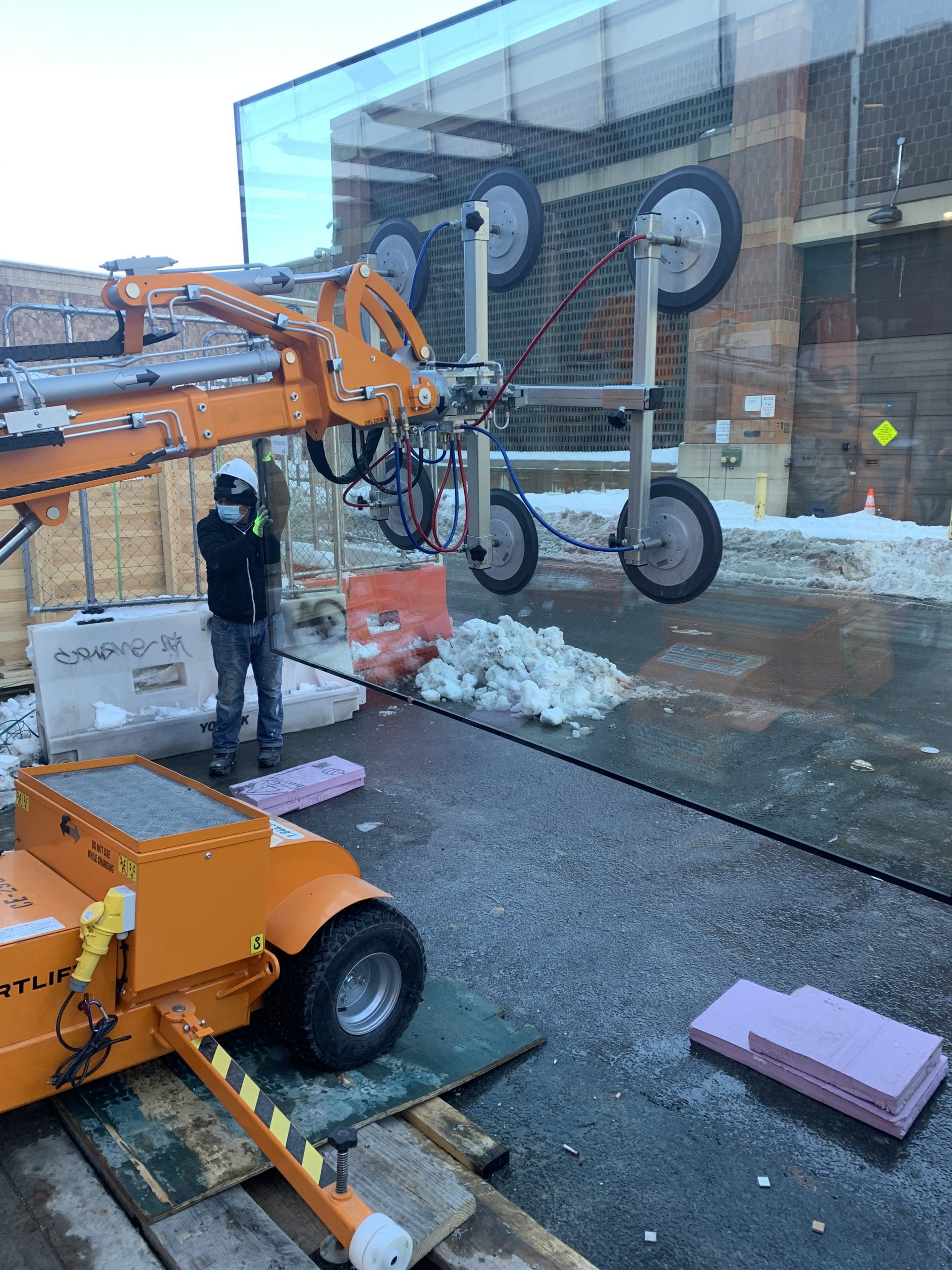 image of large crane installing IGU at showwrom